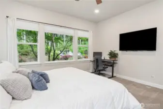 Just look at that beautiful view outside the lovely primary bedroom. So spacious and sleek.