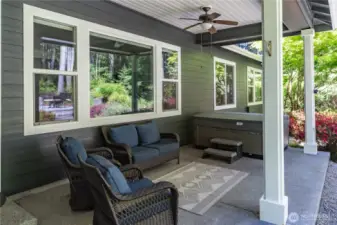 You can entertain and enjoy the outdoors all year long under this covered porch. Note the hot tub in the background! There is also a propane hook-up for your barbecues, plus a ceiling fan and light.