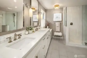 Updated primary bathroom has dual sinks, radiant floor heating and extra storage space.