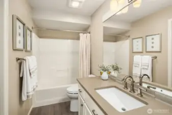 Upstairs guest bathroom has soothing colors and is very spacious.