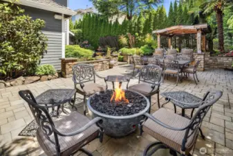 Custom firepit entices everyone to come over and enjoy some time together. Lighted walkways and sprinkler system throughout the yard.