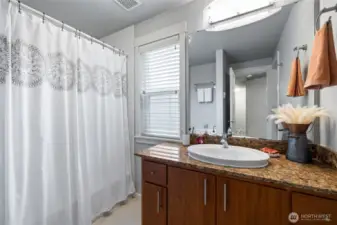Full bath with natural light through privacy window.