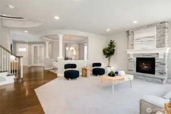 Oversized family room with cozy, stone surround gas fireplace.