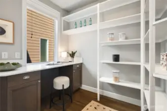 Wow! Working pantry with countertop space for coffee maker, built-in shelving, and additional Costco storage room.