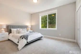 Generous sized bedroom with backyard views.