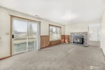 The large family room features a sliding glass door to the backyard and a pellet stove capable of heating the entire home.