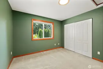 Freshly painted secondary bedroom, window to the side yard