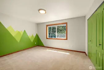 Custom painted secondary bedroom, largest of the three. Window to the back yard and custom built in closet for organization