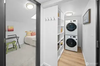 Walk-in pantry off kitchen with stackable washer and dryer.