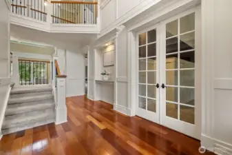 French doors to the office and past the inset is the primary bedroom.