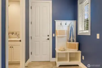 The door in the center leads to the two car garage. There's a door on the right leading to a single car garage. Laundry room to the left.