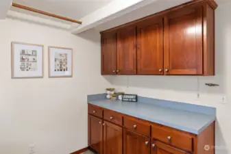 Generous laundry cabinetry, sorting counter and even hanging rods make laundry a breeze!