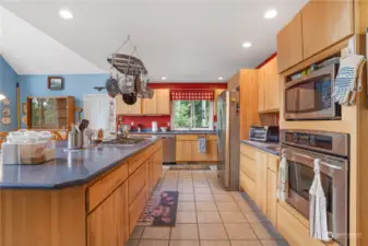 Large kitchen with tile floors and hard surface counter tops.  Build in Microwave, can lights