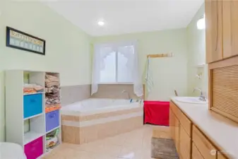 Tile floors with sunken tub, lots of counter space.