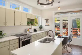 The gorgeous kitchen is light and bright with transom windows, quartz counterops and updated appliances.