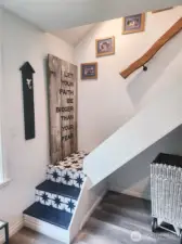 Stairs from mudroom up to second floor.  Tile coordinating with decor of the home.