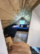 At the top of the stairs to the right is a spacious media area that can also be used as an area for guests to sleep.