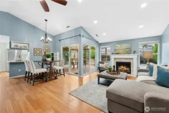 Light and bright with vaulted ceilings, canned lighting, and large windows overlooking the backyard, including TWO sliders to the covered deck.