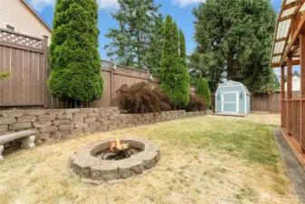 Private, stylishly updated retaining walls, firepit, and a shed--this backyard really does have it all!