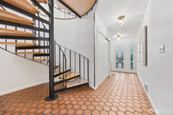 Entryway on lower level. Entrance from driveway directly to main floor, so you don't have to use the spiral staircase
