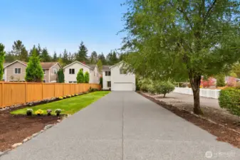Long flat driveway.  Woods behind house open onto trails.