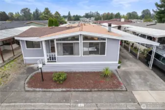 The home has a deep carport with enough space for two large vehicles to be covered