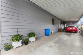 There is a deep carport with the entrance to the home / utility room up the stairs to the left. There is a secure storage shed at the end of the carport