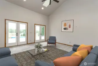 Family room with two sets of French Doors onto the private back deck over looking the property and mountain view