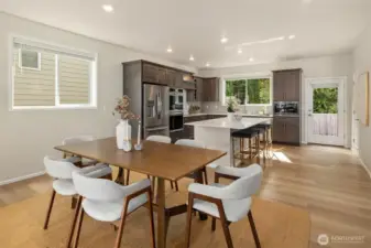 Dining facing kitchen and backyard. Light bright and open.
