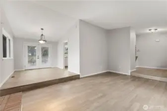 From living room, enter into dining area, and to rear french doors.