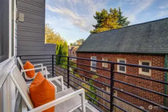 The sitting deck on the front of the townhome faces south, accessed from the second-level bedroom.