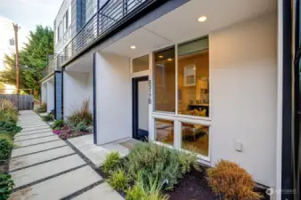 6317 34th Ave SW Unit B, is tucked behind the street fronting units in a quiet spot on the south side of the complex. You head down a landscaped path from 34th Ave SW, to the unit. It also it has easy access to the alley where the off-street parking space is located.