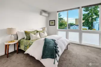 Large primary bedroom on the top level with floor-to-ceiling windows with privacy glass and pull-down or up custom shades. Efficient mini-split air-conditioning to keep you cool all summer long!