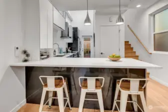 The breakfast dining bar is perfect for morning coffee, or chopping and chatting while hosting friends for dinner. The door leads to a large pantry and has additional storage space under the stairs perfect for storing all your gear.