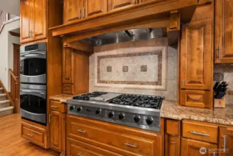 If you love to cook then you will appreciate this Viking Cooktop and & hood vent, the double wall ovens, and the deep pull out drawers and built-in spice racks spice racks.  The kitchen also features slab granite counters and beautiful tiled backsplash, and under the cabinet lighting too.