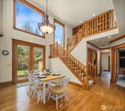 Notice the large windows on the south side of the house that brings in the natural daylight to this house.  This also shows the 2nd staircase going up into the loft / library room, and the 4 bedrooms upstairs.