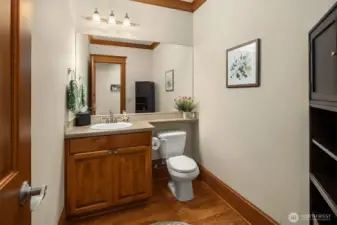 A larger powder room off the kitchen and media room