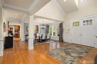 The grand foyer has an inlaid tile entryway with beautiful hardwood floors throughout the main level   common areas.  The high windows over the double front doors draws in the natural daylight.