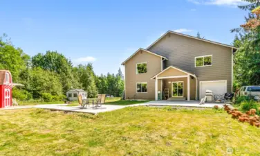 Back of home with concrete walk
