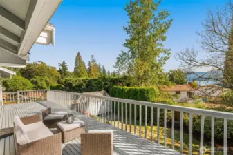 Deck overlooking the outdoor sanctuary and lake views.