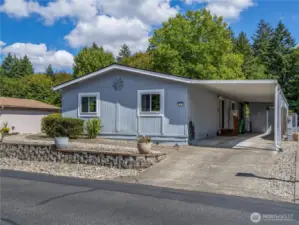 This home has a carport with an electric vehicle charger and a storage shed with electricity.