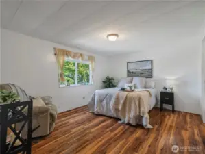 The primary bedroom is spacious and has a large closet and an ensuite.