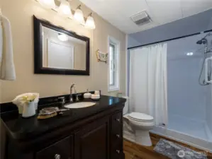 Primary bath with its dark wood cabinets and black granite countertop is beautiful. The oversized walk in shower makes taking care of grooming a breeze.