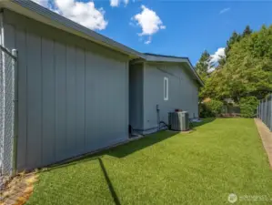 The fully fenced back yard has artificial grass for easy maintenance. the home has AC.