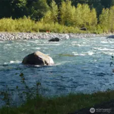 The river rushes around Beer Rock, an 8-foot-high boulder just off the park area. Kayakers play on the right side of the boulder in an eddy with calmer water. Pink salmon (humpies) are now migrating upstream past the park.