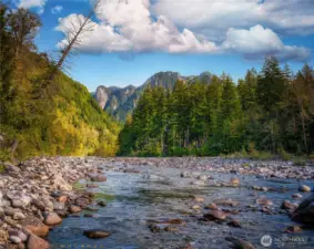 The north fork of the Skykomish River on a peaceful September morning. The park-like open meadow is about 20 feet to the left of the rocks and is out of the photo.