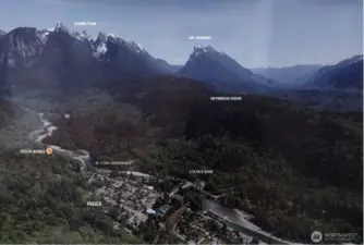 The orange circle shows location of the property for sale. Dominating the view to the east is a range of peaks, some within the recently designated Wild Sky Wilderness. The Skykomish River winds its way through the valley and past the town. The town’s famed rock climbing cliffs are out of sight above Index.