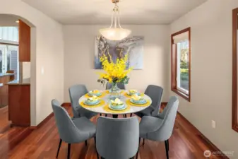 Dining room offers stunning hardwood floors, arched entries, and full wrap clear fir window millwork.