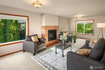 Living room features large corner-set windows, square gas fireplace with marble surround, and lush carpet.