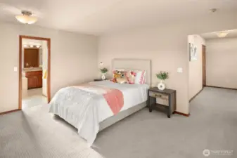 Primary Suite & Sitting Room with lake view from large corner-set windows.